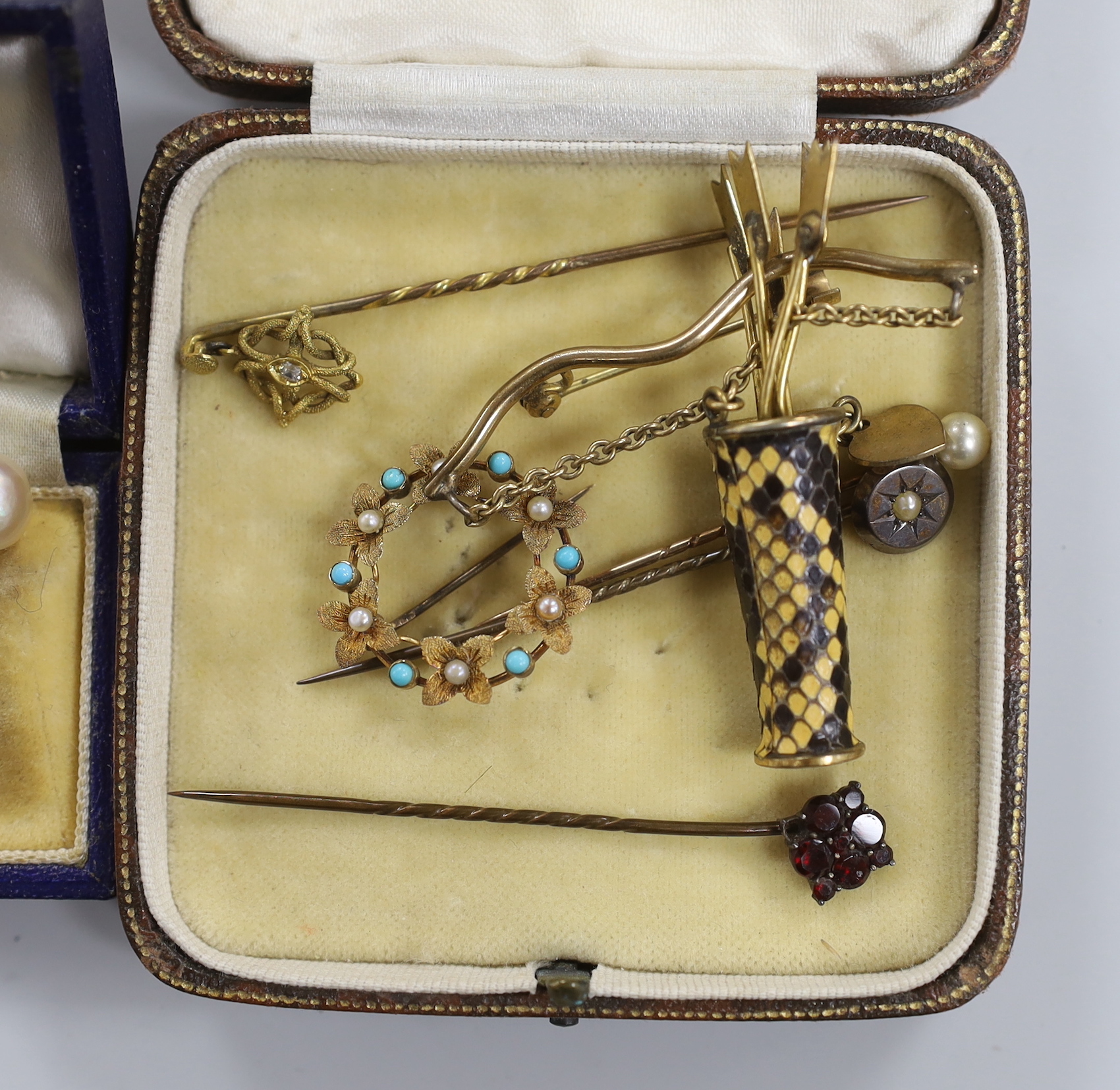 A pair of 9ct white metal and cultured pearl ear clips, a circular brooch, arrow and quiver brooch and four stick pins